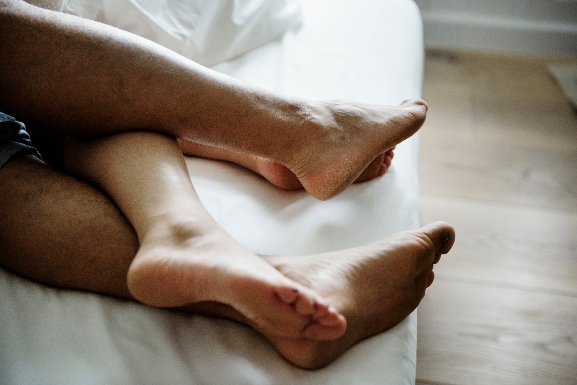 Legs of a couple sleeping in bed